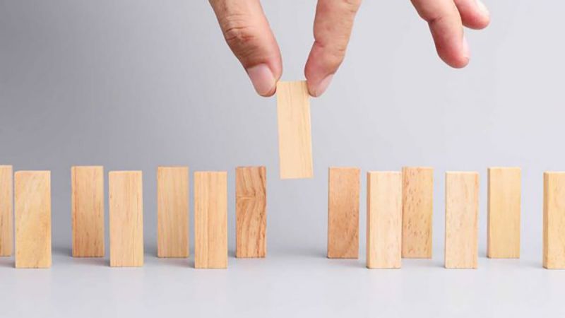 hand selecting an object from a line