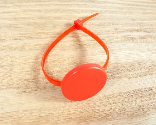 Close up image of an NFC Reusable Disc NFC Cable Tie
