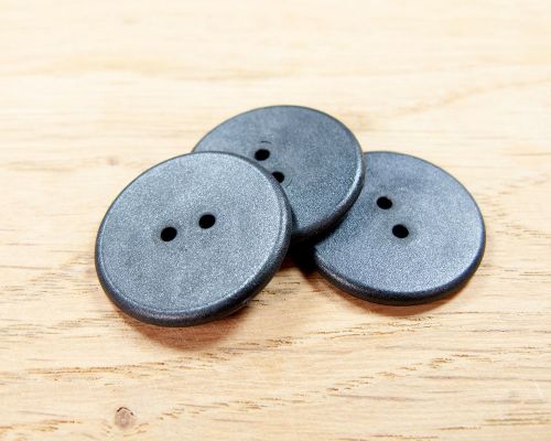 Close up image of an NFC Button Laundry Tag