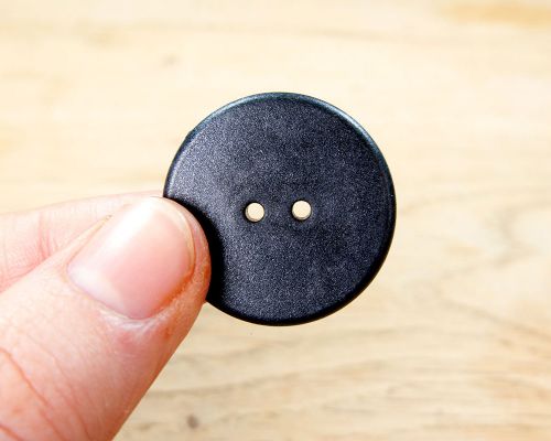 Side view of the NFC Button Laundry Tag