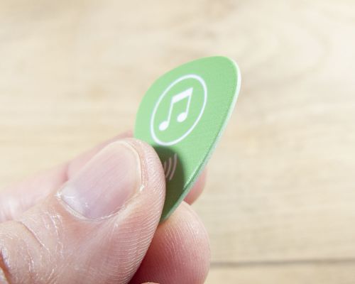 Close up image of an NFC Custom Print Guitar Pick