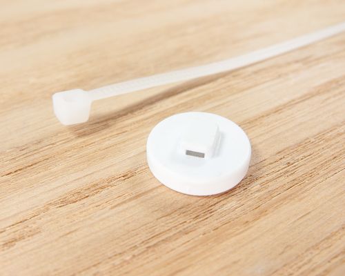 Close up image of an NFC Reusable Micro Disc NFC Cable Tie